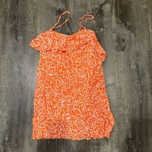 Super cute orange dress with a ruffle down the left side!